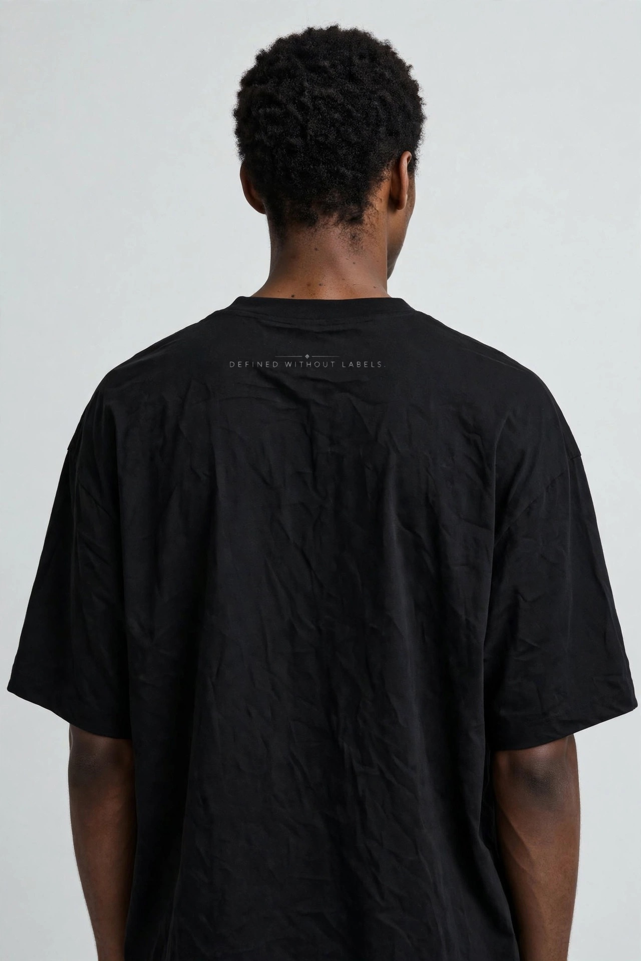 Oversized T-shirt, back view, with Defined Without Labels. across the upper back.