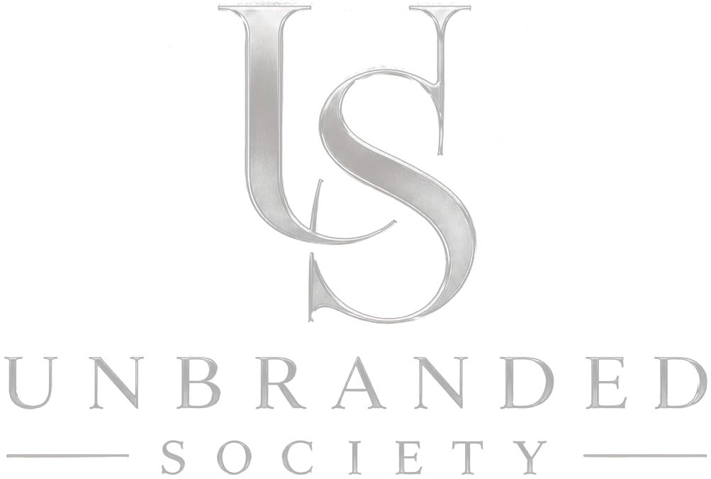 Unbranded Society logo: a silver interlocked US monogram above the words Unbranded Society.