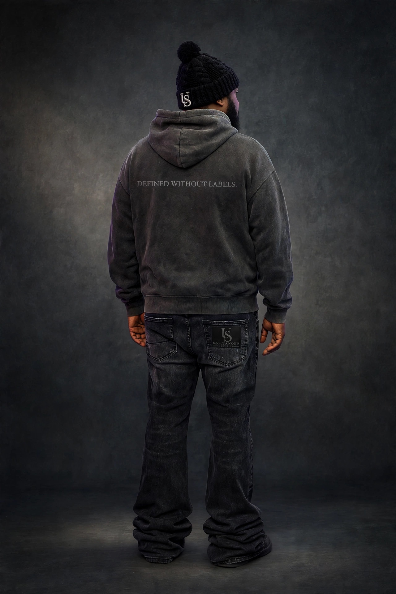 The Unbranded Society outfit, back view: Defined Without Labels. across the upper back of the hoodie.